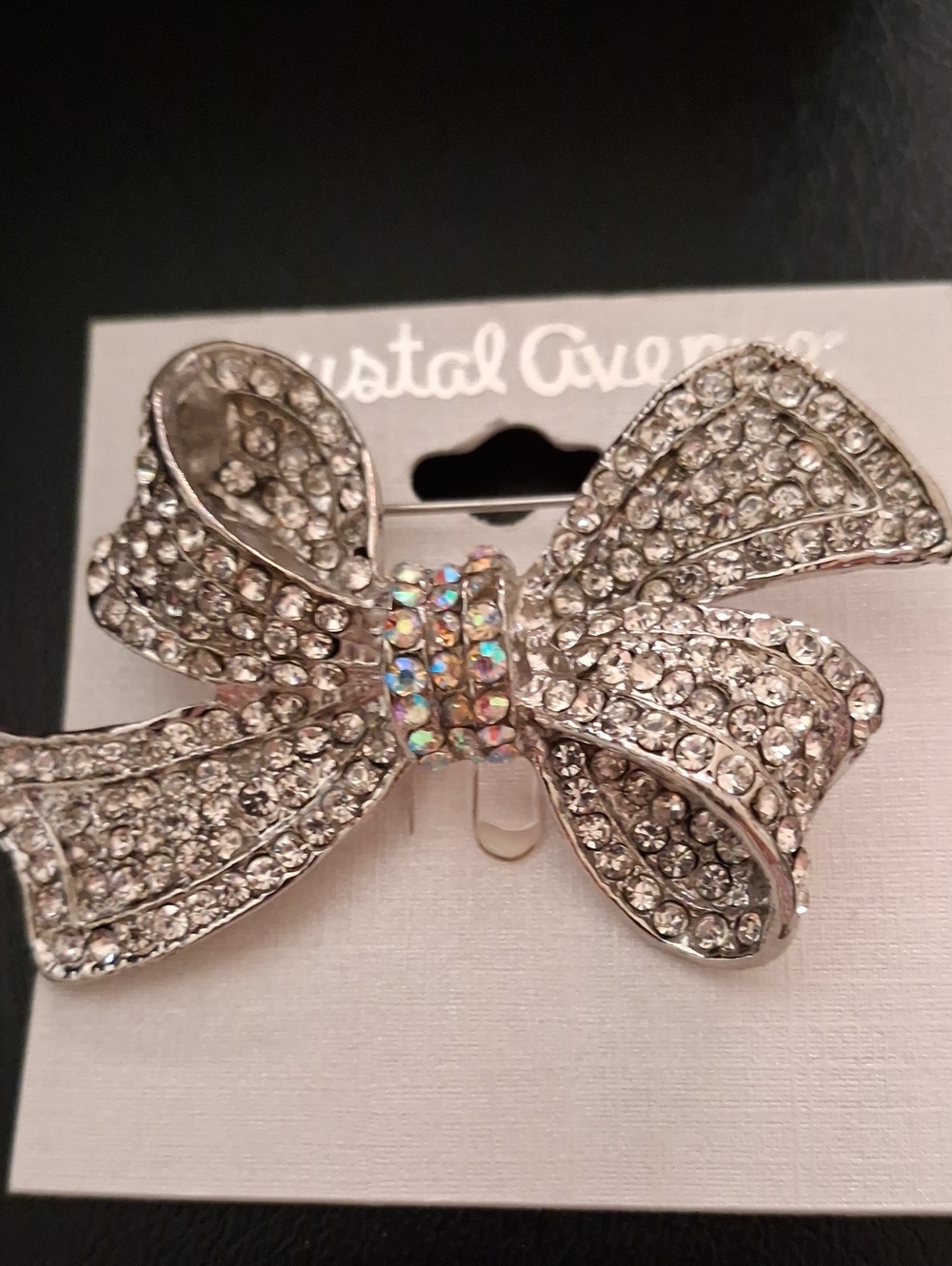 Crystal-Embellished Silver Bow Pin with Iridescent Center